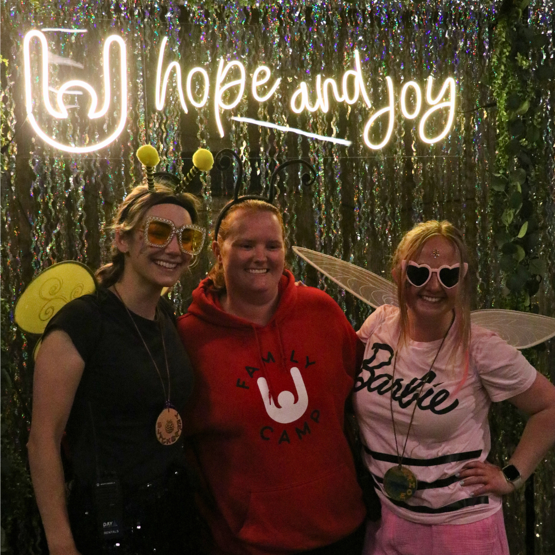 Tahoe & rainbow team with hope & joy sign 