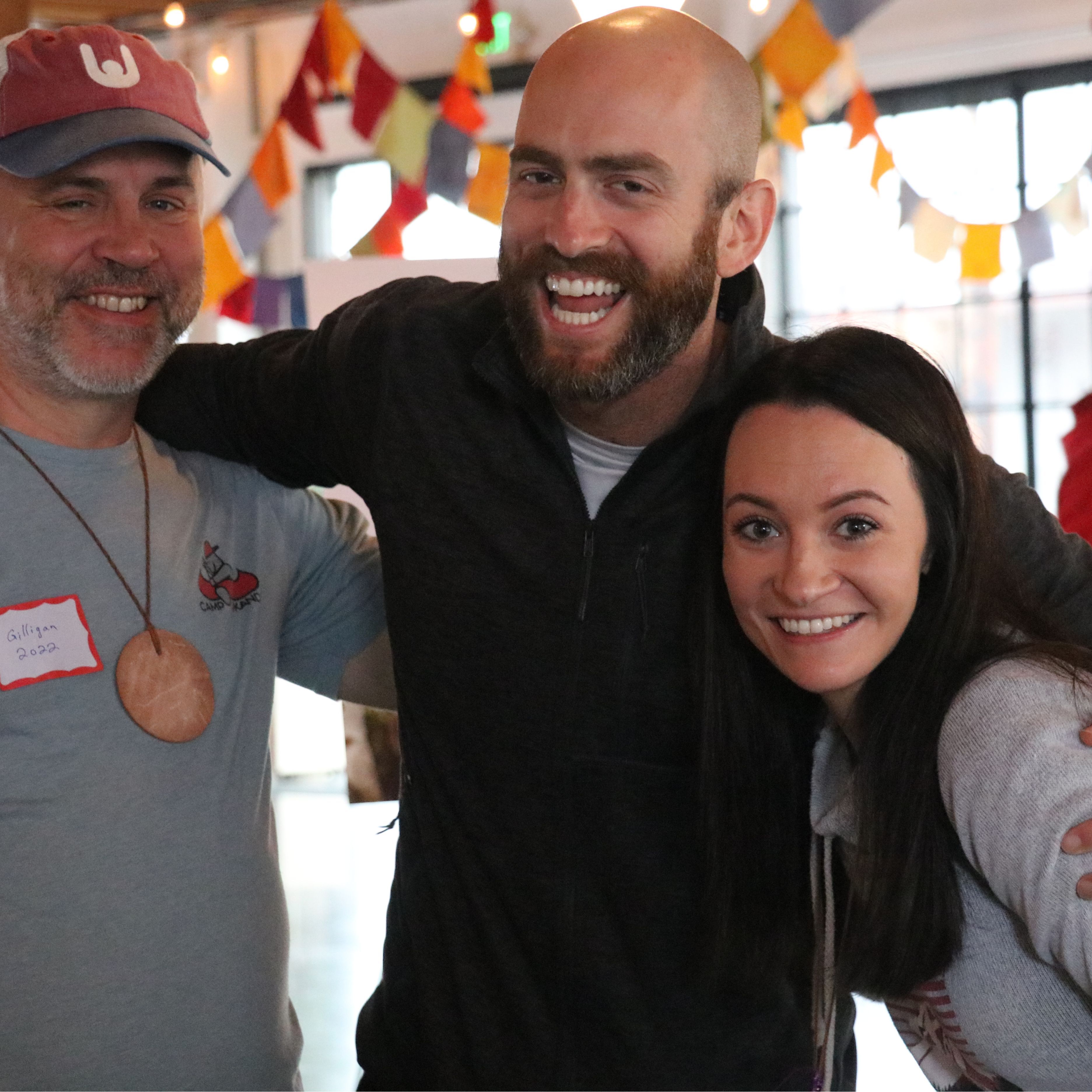 three volunteers smiling