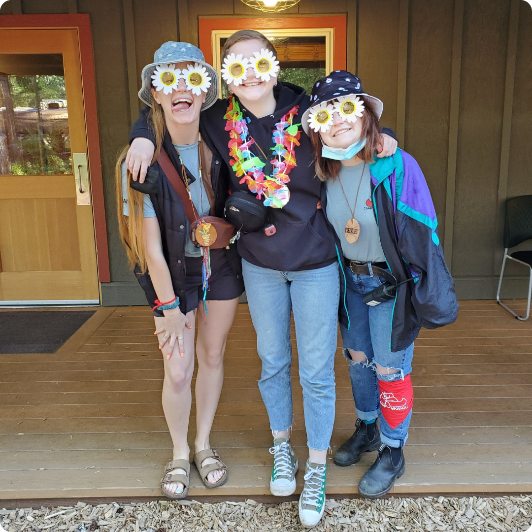 Carrot top with two Ukandu volunteers in matching sunglasses