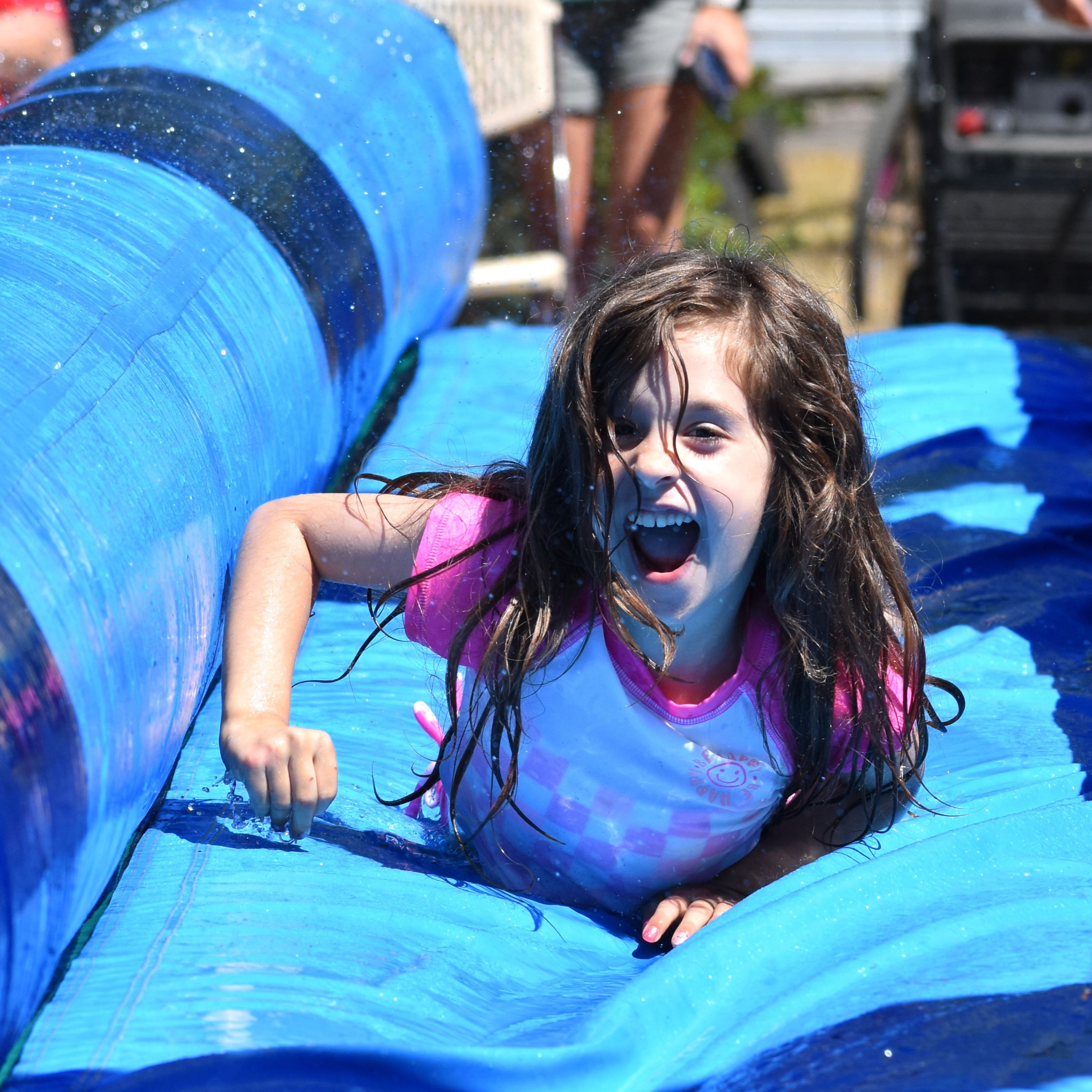 Girl smiling going down a water slide