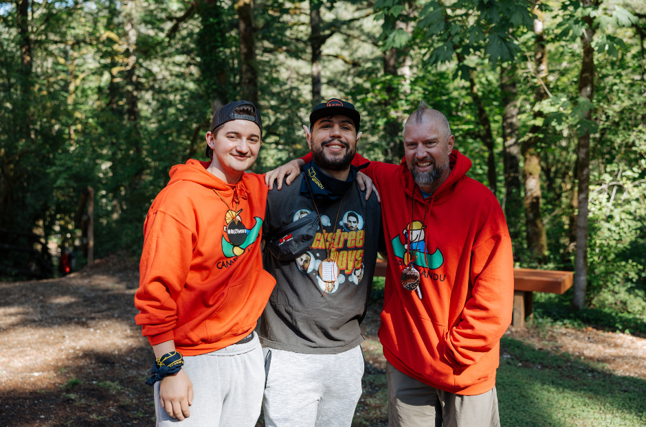 Three male volunteers with arms around each other