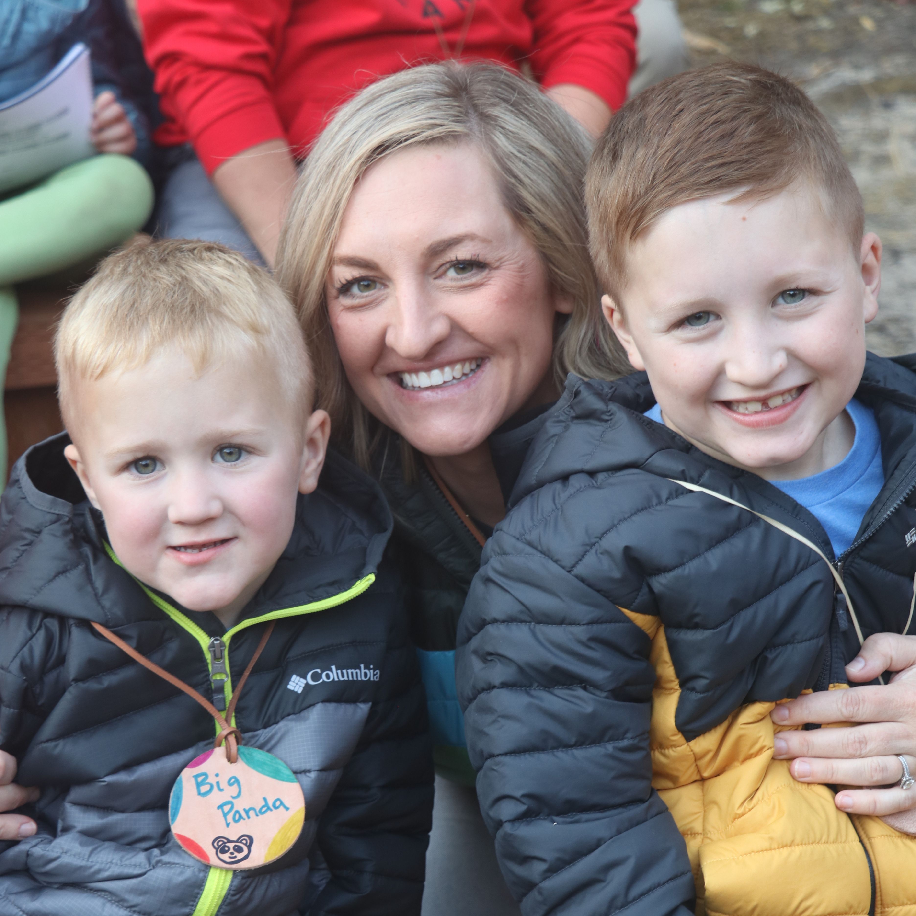 Mom and two sons smiling