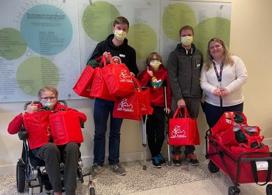 Kids holding care packages at the children's hospital