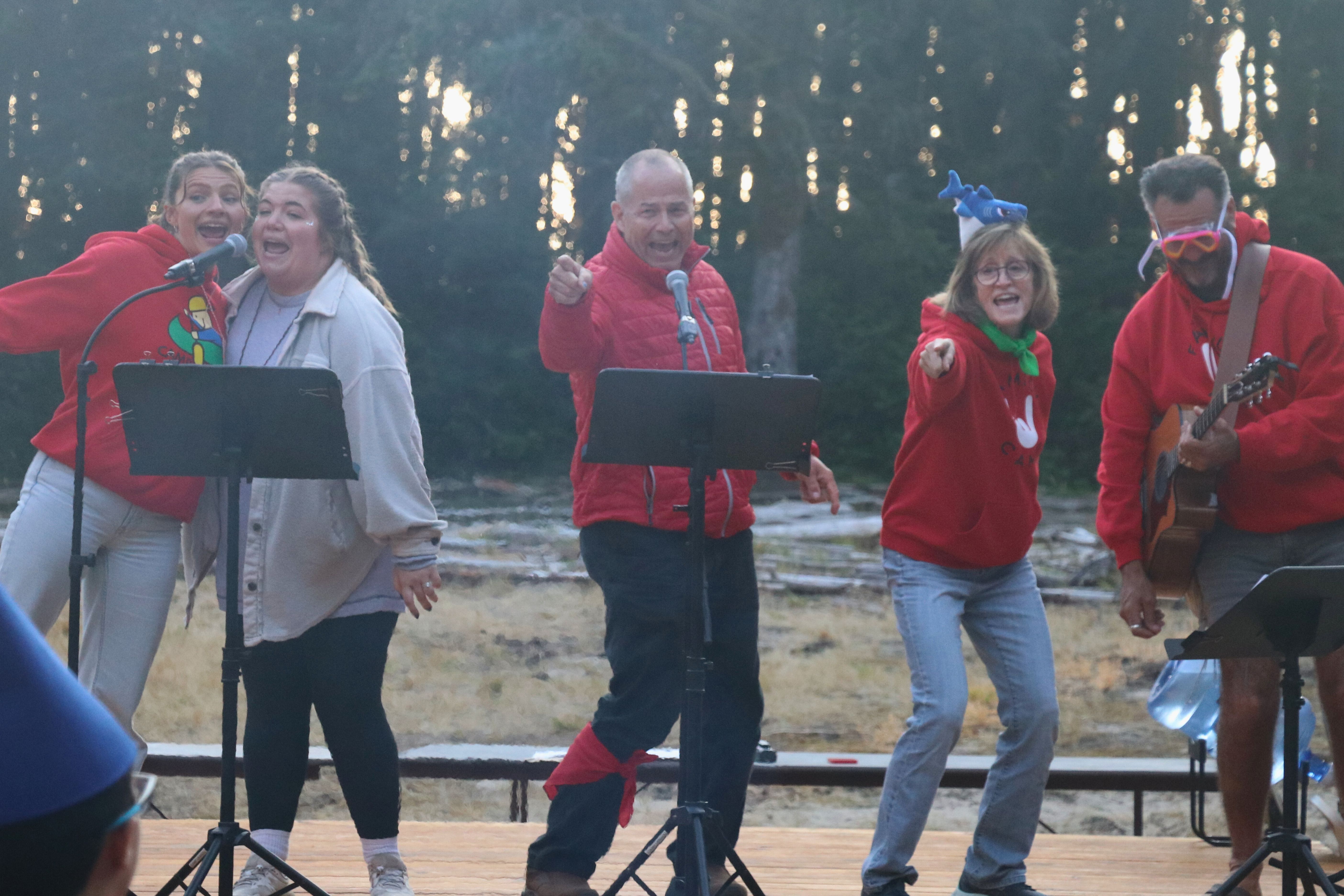 Ed and other volunteers singing on stage