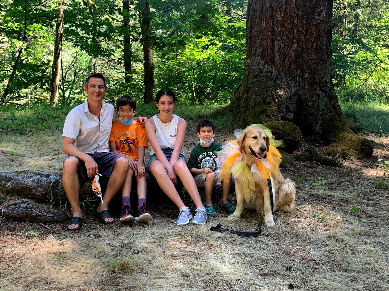 Family and Dog sitting on log